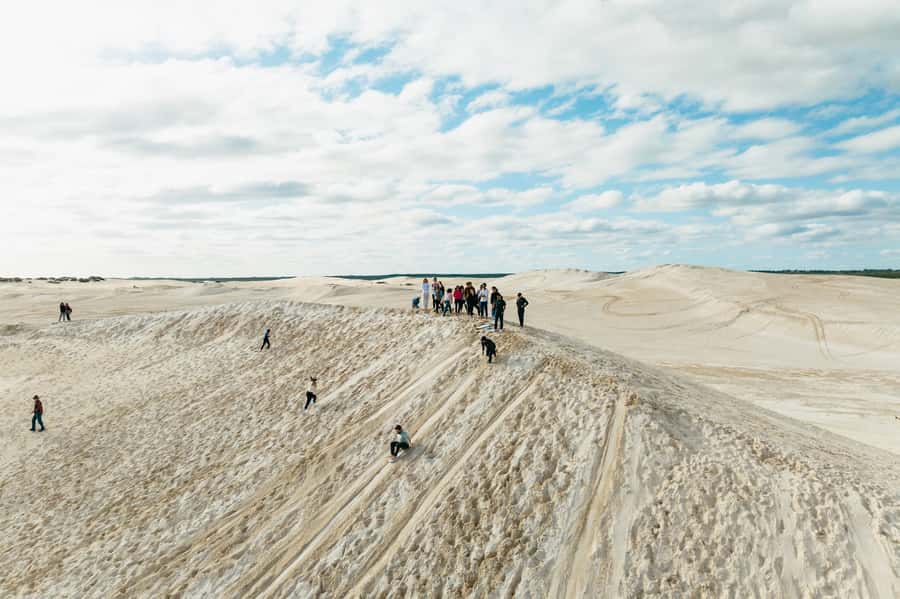 Pinnacles Desert: Sunset BBQ & Stargazing Tour +Sandboarding - Sandboarding the white dunes at Lancelin