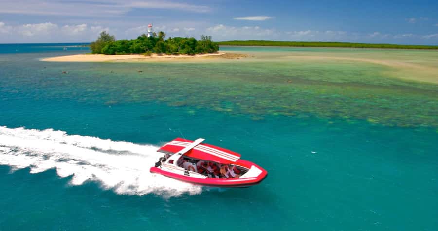 Port Douglas: Half-Day Low Island and Lagoon Snorkeling Tour - Arriving by glass-bottom boat