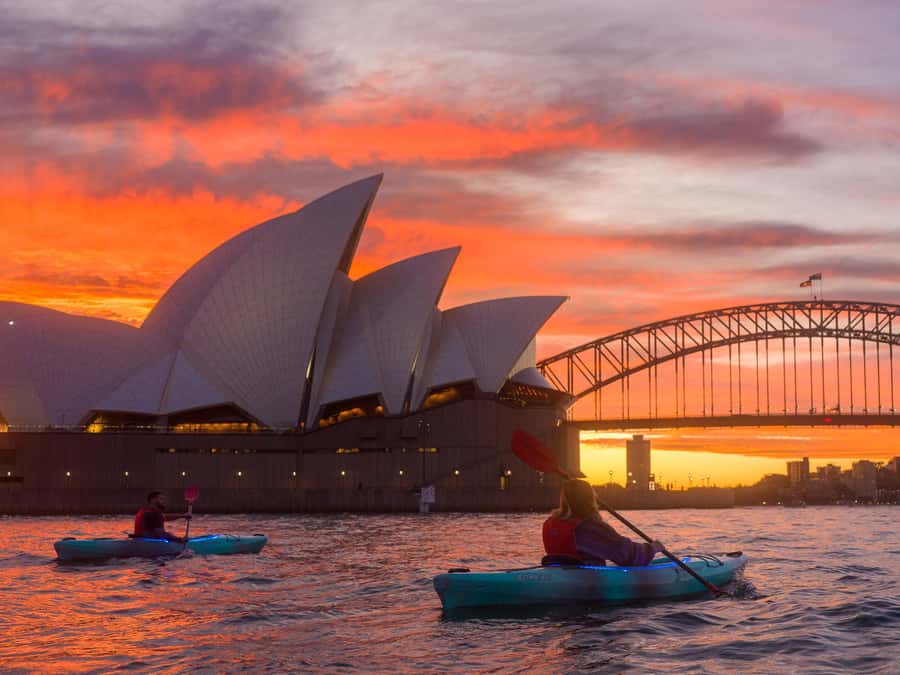 Kayakers on Sydney Harbour at first light below the Opera House